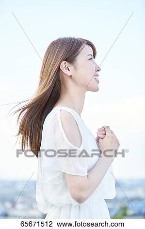 Attractive Japanese woman in a city park View Large Photo Image Stock Image - Attractive Japanese woman in a city park. Fotosearch
