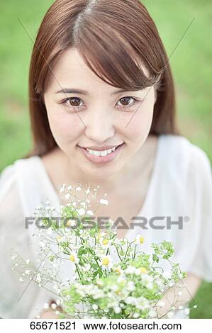 Attractive Japanese woman in a city park View Large Photo Image Stock Image - Attractive Japanese woman in a city park. Fotosearch
