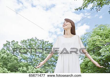 Attractive Japanese woman in a city park View Large Photo Image Stock Photo - Attractive Japanese woman in a city park. Fotosearch