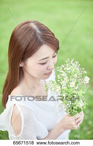Attractive Japanese woman in a city park View Large Photo Image Stock Photo - Attractive Japanese woman in a city park. Fotosearch