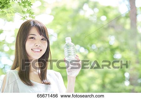 Stock Photograph - Attractive Japanese woman in a city park. Fotosearch