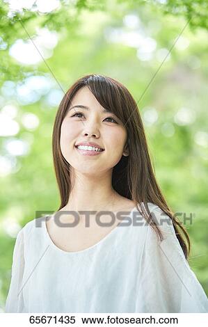 Attractive Japanese woman in a city park View Large Photo Image Stock Photography - Attractive Japanese woman in a city park. Fotosearch