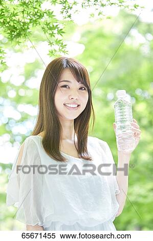 Attractive Japanese woman in a city park View Large Photo Image Stock Photography - Attractive Japanese woman in a city park. Fotosearch