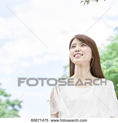Attractive Japanese woman in a city park View Large Photo Image Stock Photography - Attractive Japanese woman in a city park. Fotosearch