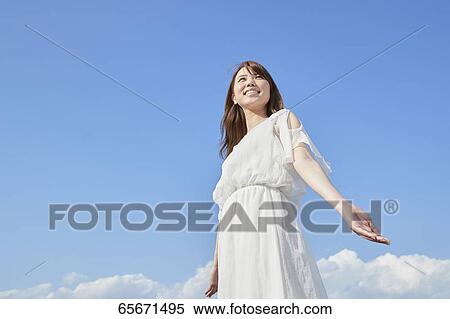 Attractive Japanese woman in a city park View Large Photo Image Stock Photography - Attractive Japanese woman in a city park. Fotosearch