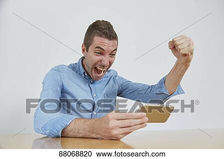 Stock Image - Caucasian man using tablet. Fotosearch