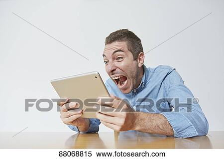 Caucasian man using tablet View Large Photo Image Stock Photography - Caucasian man using tablet. Fotosearch