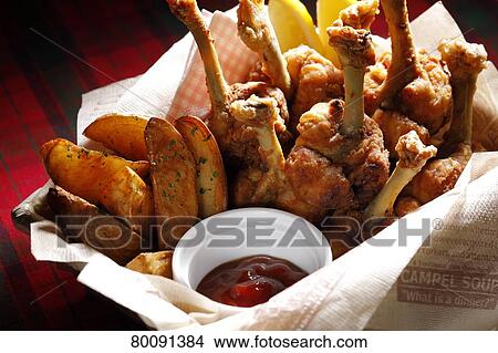 Picture - Chicken and fried potatoes. Fotosearch