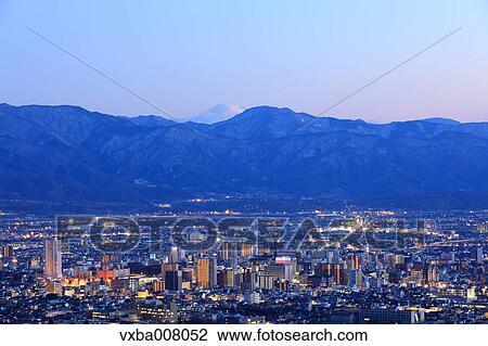 Stock Image - City lights and mountainscape, Yamanshi Prefecture, Japan. Fotosearch