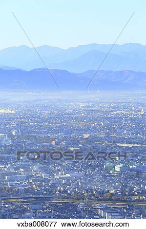 Stock Photo - City lights and mountainscape, Yamanshi Prefecture, Japan. Fotosearch
