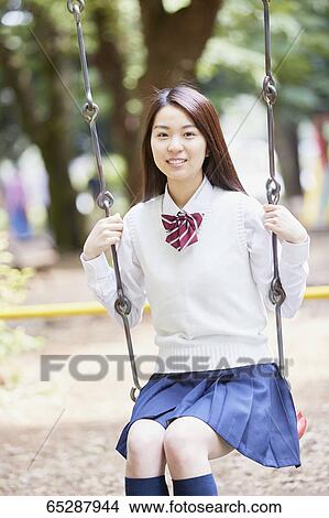 Cute Japanese high school student in a city park View Large Photo Image Picture - Cute Japanese high school student in a city park. Fotosearch