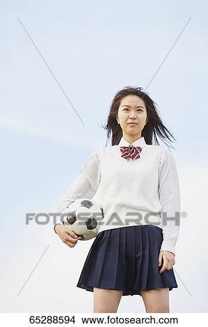 Picture - Cute Japanese high school student in a city park. Fotosearch