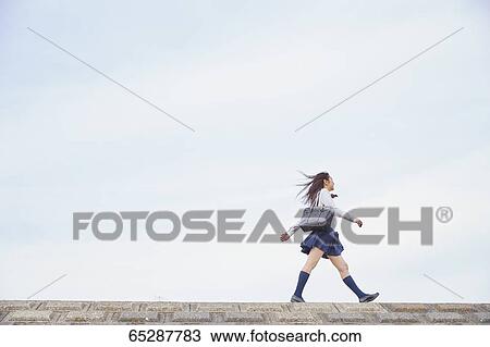 Cute Japanese high school student in a city park View Large Photo Image Stock Image - Cute Japanese high school student in a city park. Fotosearch