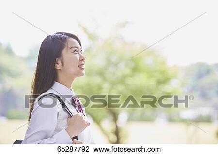 Cute Japanese high school student in a city park View Large Photo Image Stock Image - Cute Japanese high school student in a city park. Fotosearch