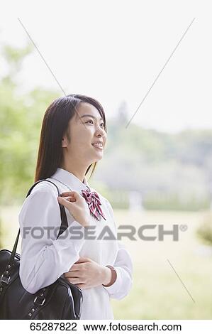 Cute Japanese high school student in a city park View Large Photo Image Stock Image - Cute Japanese high school student in a city park. Fotosearch