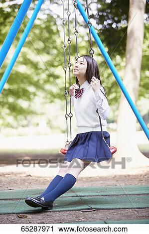 Cute Japanese high school student in a city park View Large Photo Image Stock Image - Cute Japanese high school student in a city park. Fotosearch