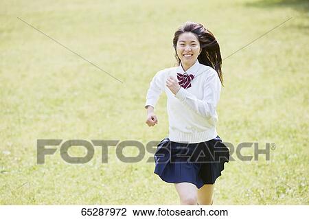 Cute Japanese high school student in a city park View Large Photo Image Stock Image - Cute Japanese high school student in a city park. Fotosearch
