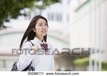 Cute Japanese high school student in a city park View Large Photo Image Stock Image - Cute Japanese high school student in a city park. Fotosearch