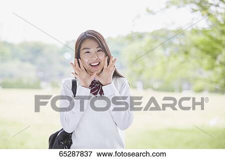 Cute Japanese high school student in a city park View Large Photo Image Stock Photo - Cute Japanese high school student in a city park. Fotosearch