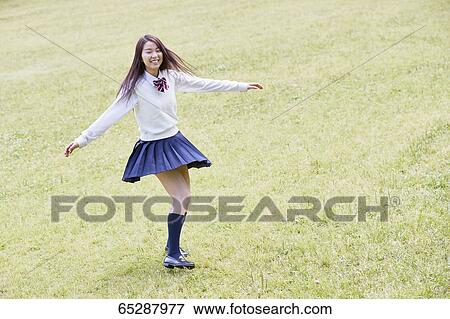 Cute Japanese high school student in a city park View Large Photo Image Stock Photo - Cute Japanese high school student in a city park. Fotosearch