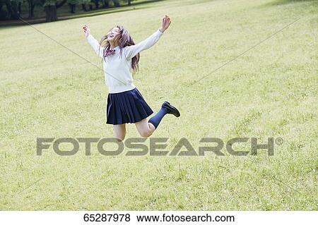 Cute Japanese high school student in a city park View Large Photo Image Stock Photo - Cute Japanese high school student in a city park. Fotosearch