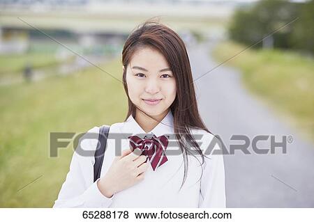 Cute Japanese high school student in a city park View Large Photo Image Stock Photo - Cute Japanese high school student in a city park. Fotosearch