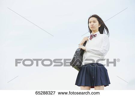 Cute Japanese high school student in a city park View Large Photo Image Stock Photo - Cute Japanese high school student in a city park. Fotosearch
