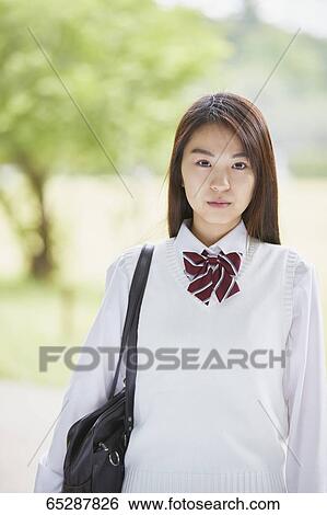 Cute Japanese high school student in a city park View Large Photo Image Stock Photograph - Cute Japanese high school student in a city park. Fotosearch