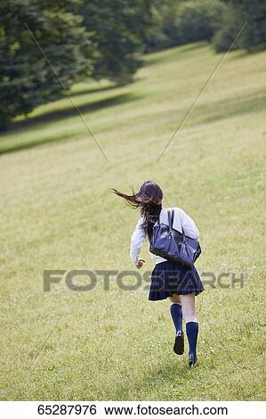Cute Japanese high school student in a city park View Large Photo Image Stock Photograph - Cute Japanese high school student in a city park. Fotosearch