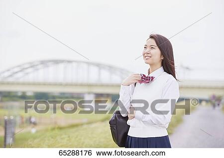 Cute Japanese high school student in a city park View Large Photo Image Stock Photograph - Cute Japanese high school student in a city park. Fotosearch
