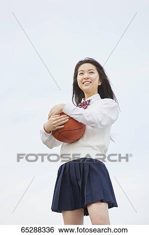 Cute Japanese high school student in a city park View Large Photo Image Stock Photograph - Cute Japanese high school student in a city park. Fotosearch