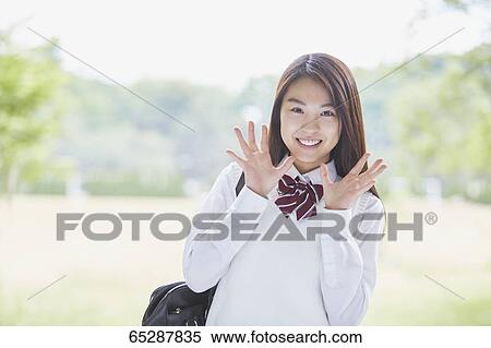 Cute Japanese high school student in a city park View Large Photo Image Stock Photography - Cute Japanese high school student in a city park. Fotosearch