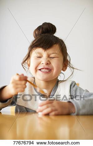 Picture - Cute Japanese kid having a snack. Fotosearch