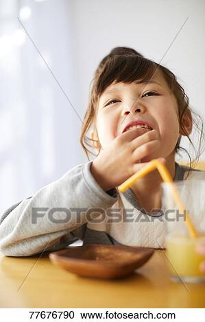 Cute Japanese kid having a snack View Large Photo Image Stock Image - Cute Japanese kid having a snack. Fotosearch