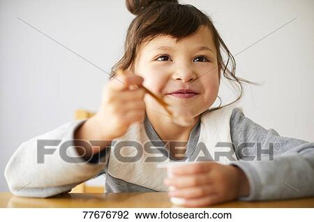 Cute Japanese kid having a snack View Large Photo Image Stock Image - Cute Japanese kid having a snack. Fotosearch