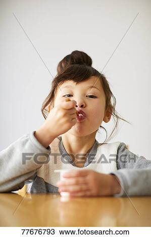 Cute Japanese kid having a snack View Large Photo Image Stock Image - Cute Japanese kid having a snack. Fotosearch