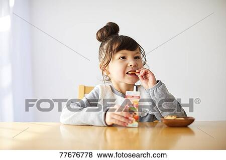 Stock Photo - Cute Japanese kid having a snack. Fotosearch