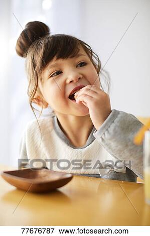 Cute Japanese kid having a snack View Large Photo Image Stock Photo - Cute Japanese kid having a snack. Fotosearch