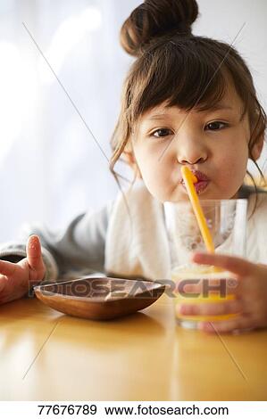 Stock Photo - Cute Japanese kid having a snack. Fotosearch