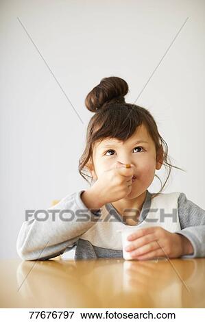 Stock Photo - Cute Japanese kid having a snack. Fotosearch