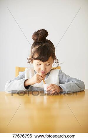 Cute Japanese kid having a snack View Large Photo Image Stock Photograph - Cute Japanese kid having a snack. Fotosearch