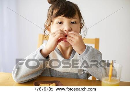 Cute Japanese kid having a snack View Large Photo Image Stock Photography - Cute Japanese kid having a snack. Fotosearch