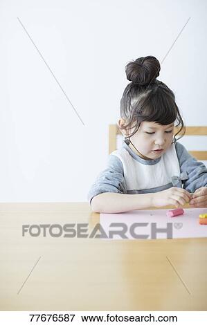 Cute Japanese kid playing with clay View Large Photo Image Stock Photo - Cute Japanese kid playing with clay. Fotosearch