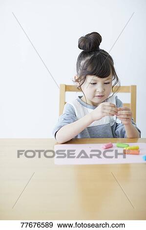 Cute Japanese kid playing with clay View Large Photo Image Stock Photo - Cute Japanese kid playing with clay. Fotosearch