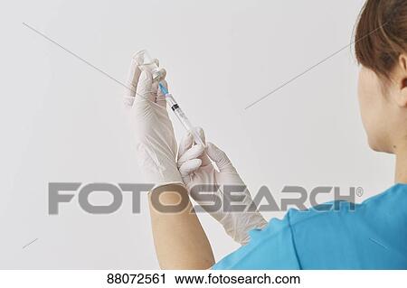 Doctor preparing injection View Large Photo Image Stock Image - Doctor preparing injection. Fotosearch