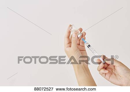 Doctor preparing injection View Large Photo Image Stock Photo - Doctor preparing injection. Fotosearch