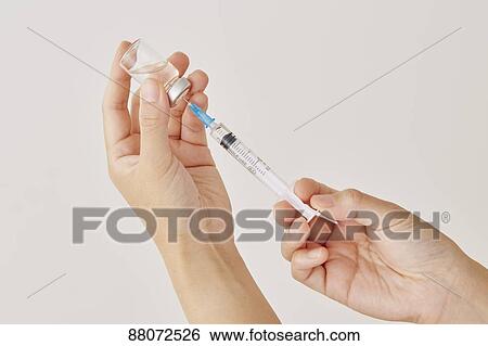 Doctor preparing injection View Large Photo Image Stock Photograph - Doctor preparing injection. Fotosearch