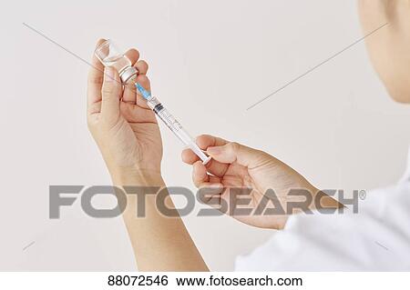 Doctor preparing injection View Large Photo Image Stock Photograph - Doctor preparing injection. Fotosearch