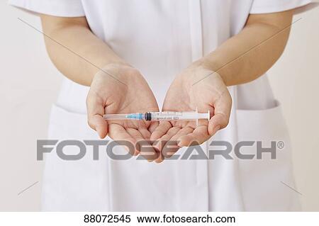 Stock Photography - Doctor preparing injection. Fotosearch