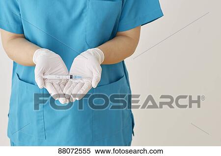Doctor preparing injection View Large Photo Image Stock Photography - Doctor preparing injection. Fotosearch